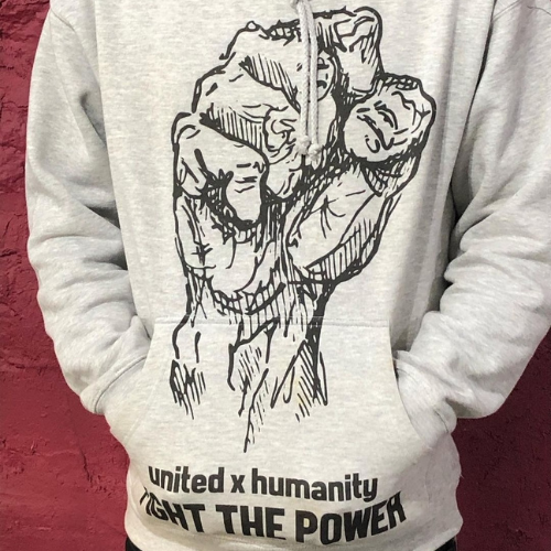 White United x Humanity, Fight the Power graphic on a heather grey hoodie, on a red background