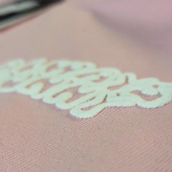 Pink fabric with white Puffed screen printing.