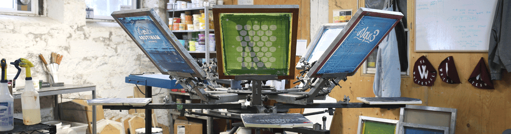 Proper Designworks Screen printing machine with blue and green screens.