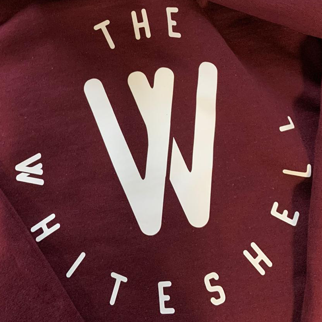 White The Whiteshell graphic on maroon fabric.