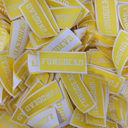 Fund Dead Woven yellow and white tag.