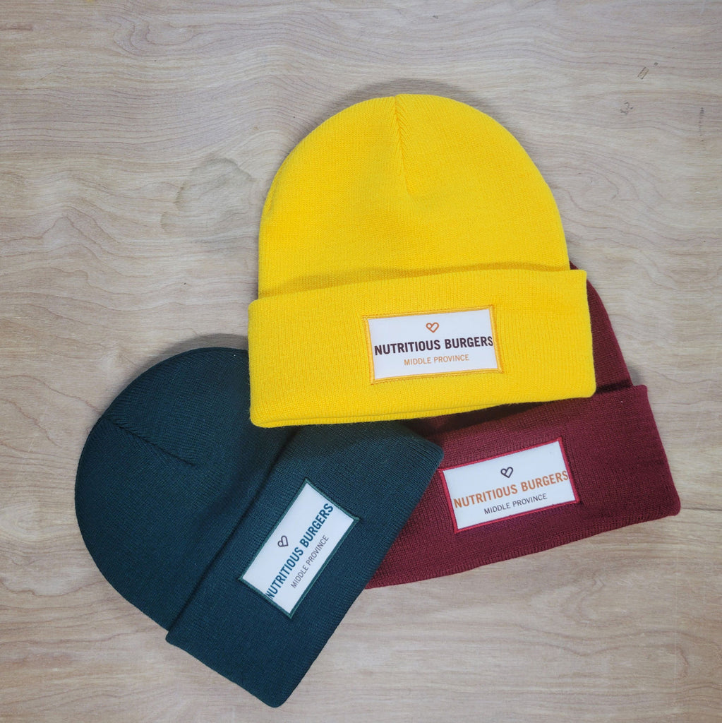 Sublimation Tags on green, yellow and red toques.